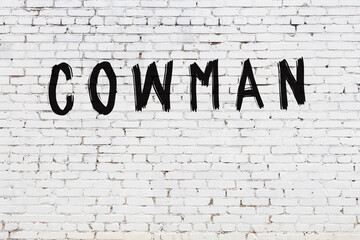 White wall with black paint inscription cowman on it