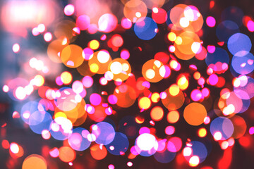 Abstract multicolored particles on black background.	
