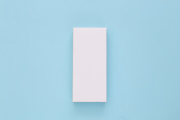 White packing box on blue background. Minimalism. Top view