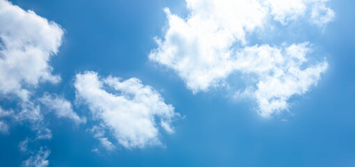 Naklejka na ściany i meble Blue sky with white clouds.soft bright clouds in blue sky with sun light