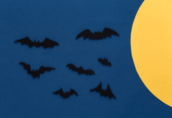 Halloween background, decorations and scary concept. Black bats fly over blue dark night background...