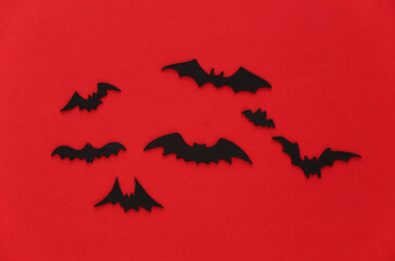 Halloween background, decorations and scary concept. Black bats fly over blood red background