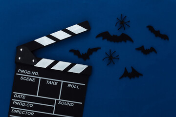 Horror movie, halloween theme. Movie clapperboard, spiders and flying decorative bats on classic...