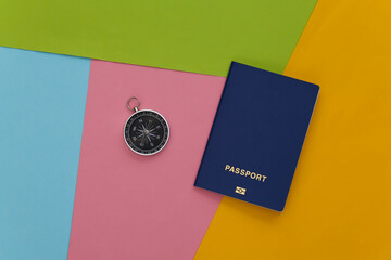 Compass and passport on colored background. Travel, adventure flat lay. Top view