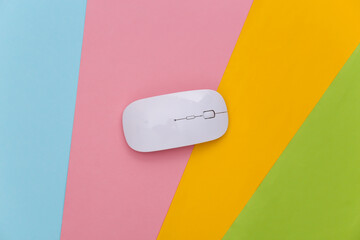 White pc mouse on colored background. Top view. Flat lay
