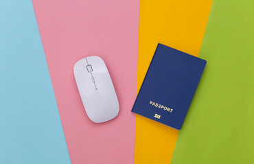 White pc mouse and passport on colored background. Top view. Flat lay