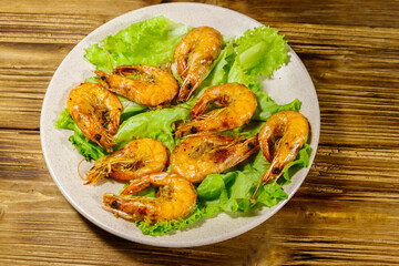Tasty baked shrimps on a wooden table