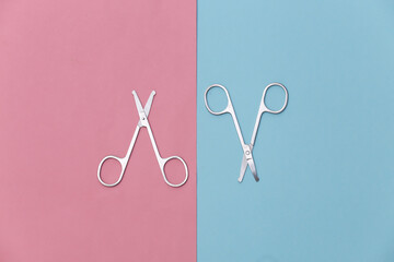 Manicure scissors on pink blue background. Beauty concept. Nail care. Top view