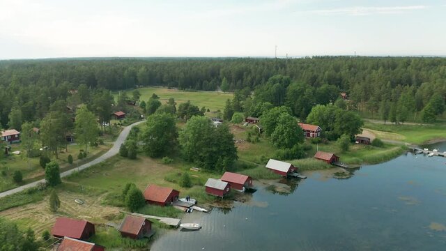 Aerial view of boathouses along shoreline in the archipelago