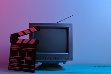 Retro tv receivers with movie clapperboard in red blue neon light. Entertainment Industry, Media 80s