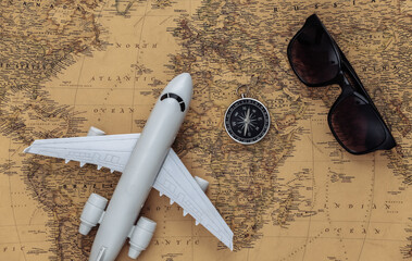 air plane, compass and compass on old map. Travel, adventure concept
