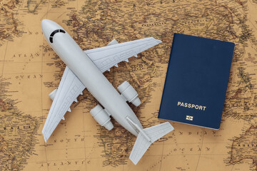 Air plane and passport on old map. Travel, adventure concept