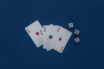 Four aces and dice on a classic blue background.