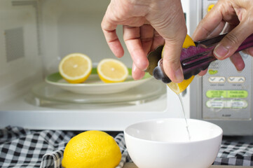 _microwaving lemons for 20 - 30 seconds before squeeze make them soft and easily squeeze; use kitchen tongs help to squeeze;  kitchen tips