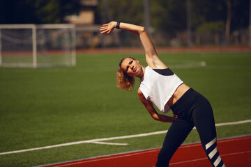 Athletic girls on stadium.