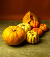 Variety of squash and pumpkins on a rustic timber wooden surface