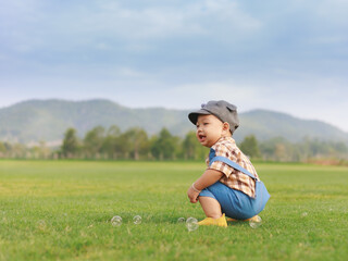 Fototapeta premium Asian toddler boy playing in nature park