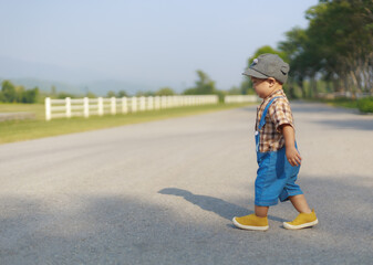 Fototapeta premium Asian toddler boy walking lonely