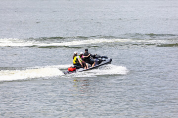 family ride a jet ski while on vacation