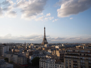Fototapeta na wymiar Paris skyline with big clouds in the cloudy sky and the Eiffel Tower