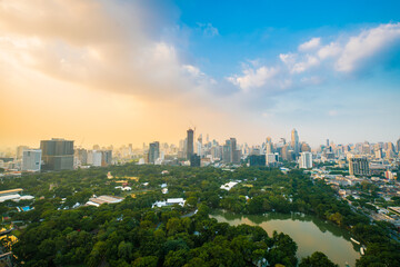 Fototapeta na wymiar Cityscape sunset sky with colorful cloud at Lumphini Park, Bangkok, Thailand.
