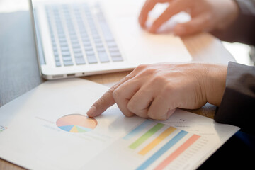 close up of business people working in office with paper work on table.