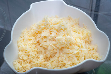 Background with grated cheese in a plate