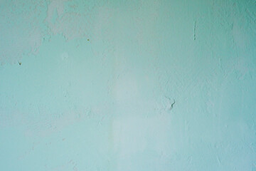 Background of uneven concrete wall painted with pale blue paint.