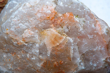 The texture of natural quartz with chips and interspersed in different shades of red with a strong increase and soft focus.