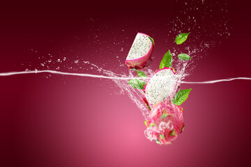 Water Splashing on Dragon Fruit or Pitaya over pink background