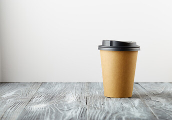 Take away paper coffee cup on grey wooden background