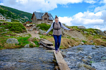 Woman Walks Over Mountain River
