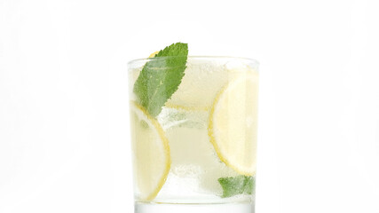 lemonade. sparkling water in glass with ice, lemon and mint. Refreshing drink with sparkling water, lemon and mint