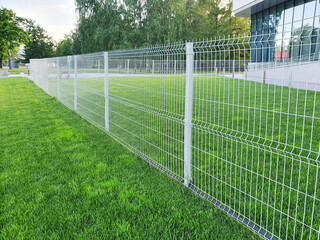 grating wire industrial fence panels, pvc metal fence panel and neatly trimmed lawn.