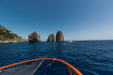 Capri, beautiful and famous island in the Mediterranean Sea, the symbol of this island in background, the faraglioni.