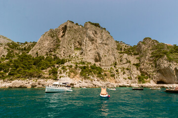 Tourist visiting caprion their boats.