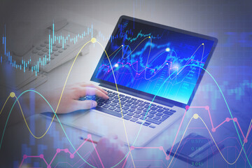 Man hands with laptop, financial graph