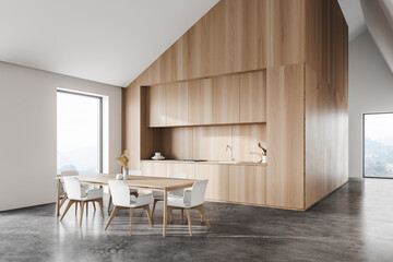 Naklejka na ściany i meble White and wooden attic kitchen corner with table