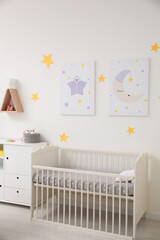 Stylish baby room interior with crib and decor elements