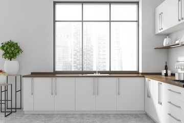 White kitchen with countertops and window