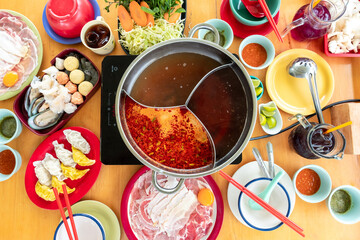 Top view set of Shabu a popular dish of pork, beef, shrimp, squid, seafood and fresh vegetables. Placed on wooden table..