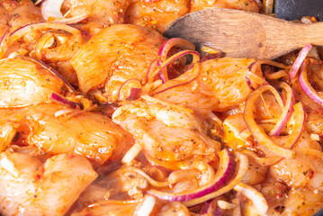 Cooking chicken with spicy sauce, Italian cuisine - Arrabbiata garlic chicken is cooked in a pan, close-up