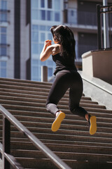 Obraz premium Street fitness, cardio workout, sport in the city. Young fit woman exercising on the stairs. Endurance and healthy lifestyle