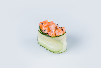 Japanese Gunkan Green Sushi with salmon and flying fish roe. Gunkan-poppy with Tobiko caviar, rice and salmon wrapped in cucumber. Side view Pan Asian dish Gunkan Sake Maki isolated on gray background
