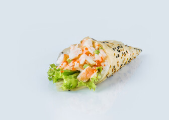 Japanese Temaki Hand Roll Sushi with black tiger shrimp flying fish roe (Tobiko caviar), salad leaf, rice, sesame seeds in Mamenori seaweed.

