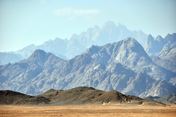 Panorama of a mountain range in the Arabian desert. An example of the sultry tonal perspective of the Egyptian open spaces. In the vicinity of Hurghada, Egypt.