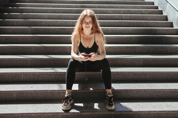 Fitness app, sport gadget, outdoor workout and technology. Fit woman with smart phone in the street
