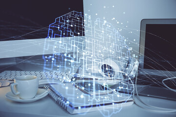 Double exposure of table with computer and brain hologram. Data innovation concept.