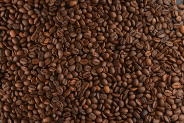 Coffee beans close-up. Roasted coffee beans background, top view.