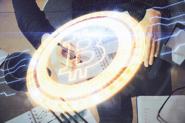 Cryptocurrency hologram over woman's hands writing background. Concept of blockchain. Double...